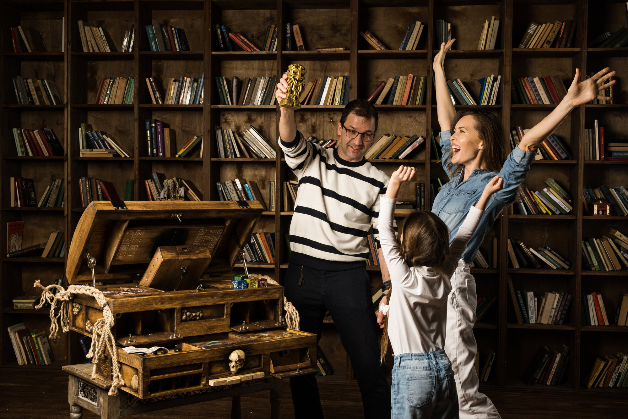 A family celebrating their win in an escape room, the kind of attraction that fills a family entertainment center